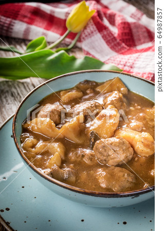 Meatballs in gravy with cast noodles. Meatballs in gravy with cast noodles. 64987857