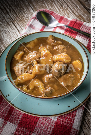 Meatballs in gravy with cast noodles. Meatballs in gravy with cast noodles. 64987860