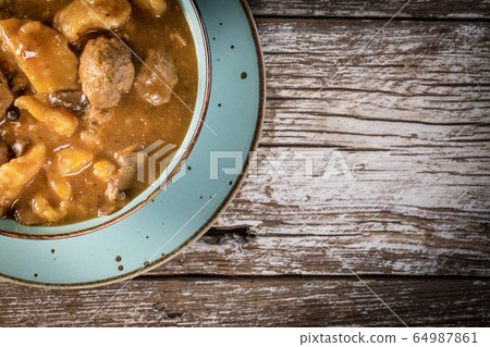 Meatballs in gravy with cast noodles. Meatballs in gravy with cast noodles. 64987861