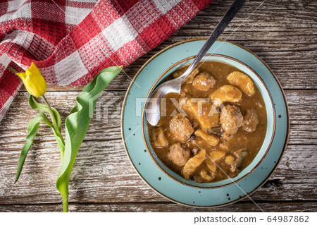 Meatballs in gravy with cast noodles. Meatballs in gravy with cast noodles. 64987862