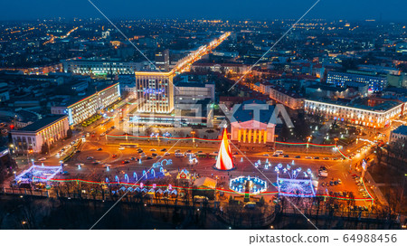 Gomel, Belarus. Main Christmas Tree And Festive Illumination On Lenin Square In Homel. New Year In Belarus. Aerial Night View Gomel, Belarus. Main Christmas Tree And Festive Illumination On Lenin Square In Homel. New Year In Belarus. Aerial Night View 64988456