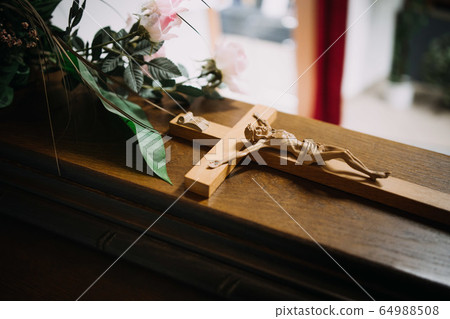 photo of a cross on a wooden casket photo of a cross on a wooden casket 64988508