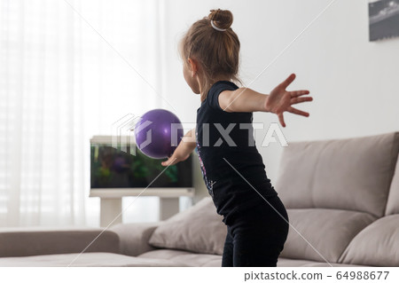 Girl gymnast performs exercises with the ball 64988677