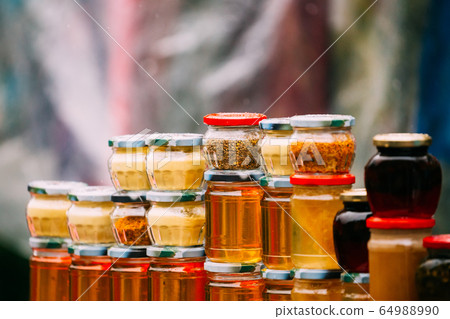 Various Jars With Sweet Tasty Yummy Jams. Jam Made From Walnuts, Pine Cones, Walnuts, Honey. Traditional Healthy Cuisine 64988990