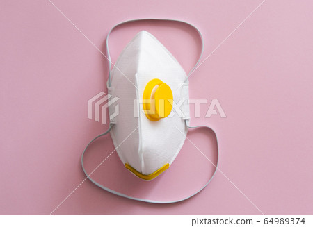 Respirator mask FFP or dust mask to cover the mouth and nose prevent coronavirus isolated on pink background. Breathing protection against air pollution, flu and coronavirus. 64989374