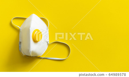 Respirator mask FFP or dust mask to cover the mouth and nose prevent coronavirus isolated on yellow background. Breathing protection against air pollution, flu and coronavirus. Respirator mask FFP or dust mask to cover the mouth and nose prevent coronavirus isolated on yellow background. Breathing protection against air pollution, flu and coronavirus. 64989378
