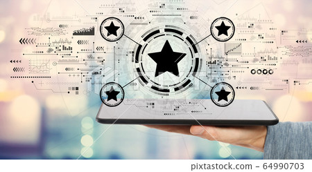 Rating star concept with tablet computer Rating star concept with tablet computer 64990703