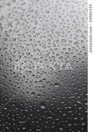 Water droplets on a stainless steel surface. 64992419
