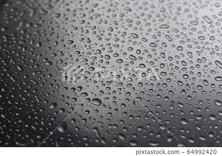 View of water droplets on a stainless steel surface. 64992420