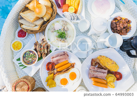 Floating breakfast set in tray with fried egg omelette sausage ham bread fruit milk juice coffee Floating breakfast set in tray with fried egg omelette sausage ham bread fruit milk juice coffee 64993003