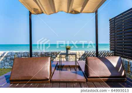 Pillow on sofa bed with lounge around beach ocean sea and blue sky 64993013