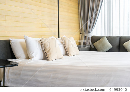 White comfortable pillow on bed decoration interior of bed room White comfortable pillow on bed decoration interior of bed room 64993040