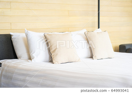 White comfortable pillow on bed decoration interior of bed room White comfortable pillow on bed decoration interior of bed room 64993041