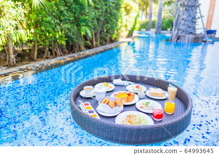 Floating breakfast set in tray with fried egg omelette sausage ham bread fruit milk juice coffee Floating breakfast set in tray with fried egg omelette sausage ham bread fruit milk juice coffee 64993645