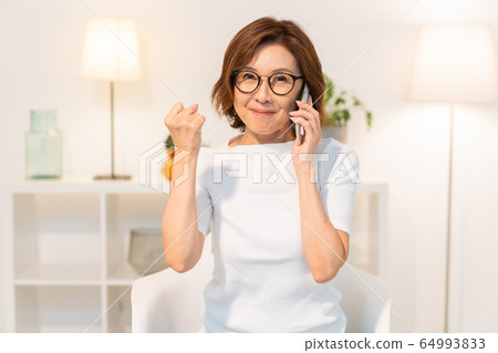Senior woman making a phone call Senior woman making a phone call 64993833