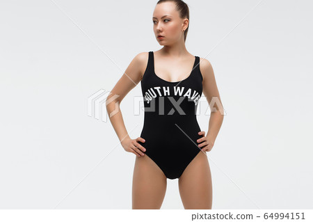 Hot woman in beachwear looking at camera Hot woman in beachwear looking at camera 64994151