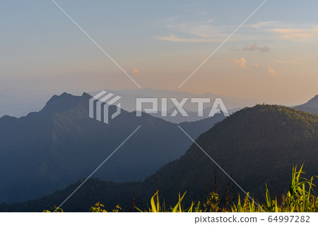 High angle viewpoint sunset over mountains and High angle viewpoint sunset over mountains and 64997282