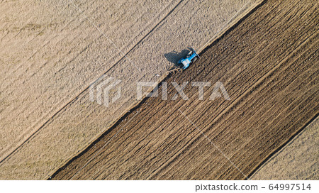 Top view of agricultural tractor vehicles working 64997514