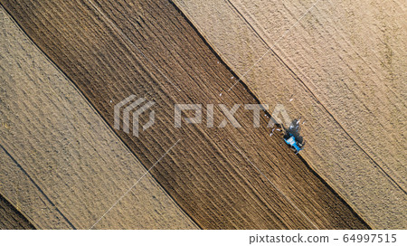 Top view of agricultural tractor vehicles working Top view of agricultural tractor vehicles working 64997515