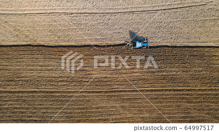 Top view of agricultural tractor vehicles working Top view of agricultural tractor vehicles working 64997517