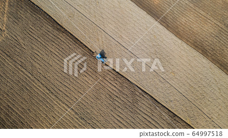 Top view of agricultural tractor vehicles working Top view of agricultural tractor vehicles working 64997518