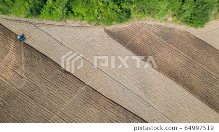 Top view of agricultural tractor vehicles working Top view of agricultural tractor vehicles working 64997519