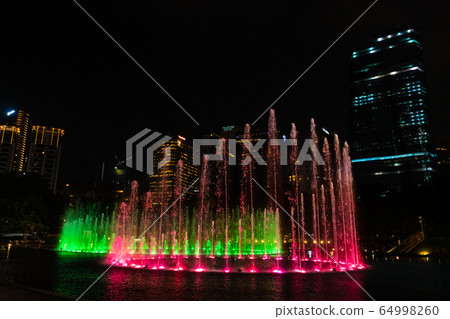 Night view of the dancing multi-colored fountains. Night view of the dancing multi-colored fountains. 64998260