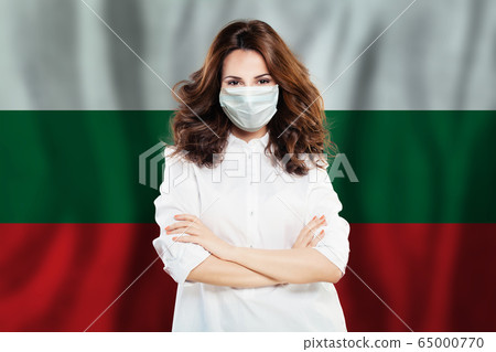 Confident doctor in a face mask against national flag 65000770