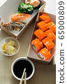 Beautiful rolls and sushi and california roll on a white table. Food delivery. Lunch. Food at home. 65000809