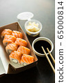 Beautiful rolls and sushi and california roll on a white table. Food delivery. Lunch. Food at home. 65000814