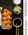 Beautiful rolls and sushi and california roll on dark table. Food delivery. Lunch. Food at home. 65000820
