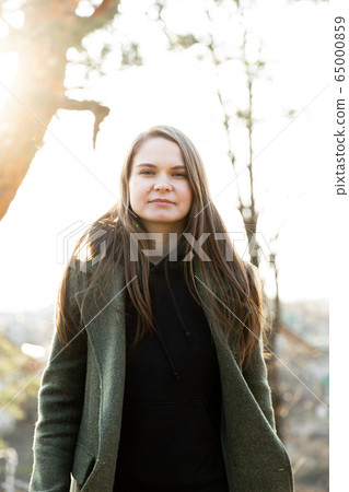 young beautiful woman in park posing for photographer young beautiful woman in park posing for photographer 65000859
