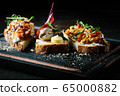 Delicious Italian bruschetta with tomato, meat pate, olives, cream cheese. Set of tasty appetizer sandwiches. 65000882