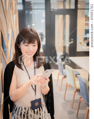 A woman with a smartphone A woman with a smartphone 65001762