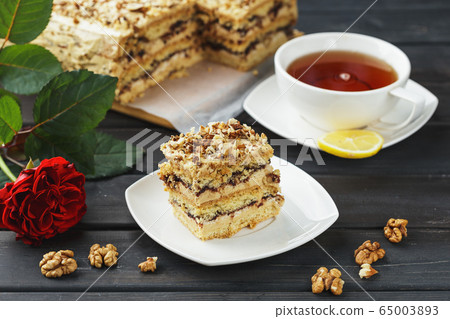 Pie with nuts on a white wooden background 65003893