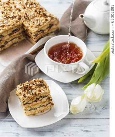 Pie with nuts on a white wooden background Pie with nuts on a white wooden background 65003895