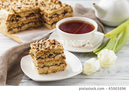 Pie with nuts on a white wooden background 65003896