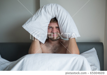 Caucasian man suffering from insomnia 65004609