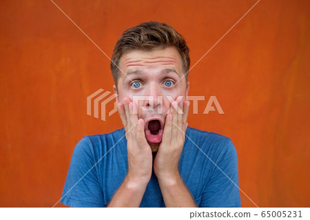 Handsome caucasian man is shocked with good news. 65005231