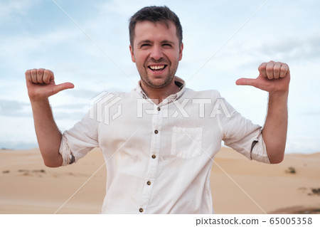 Self-satisfied and proud caucasian young man looks 65005358
