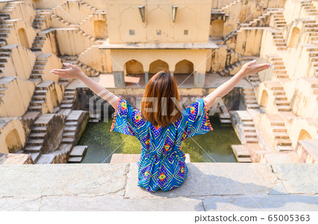 Portrait of young woman in Panna Meena ka Kund step-well at Jaipur, India 65005363