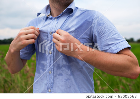 Man with hyperhidrosis sweating very badly under 65005568