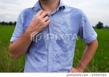 Man with hyperhidrosis sweating very badly under Man with hyperhidrosis sweating very badly under 65005569