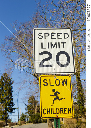 Road sign displaying 20 mph speed limit warning 65005877