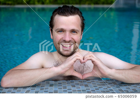 Handsome smiling young caucasian man makes the 65006059