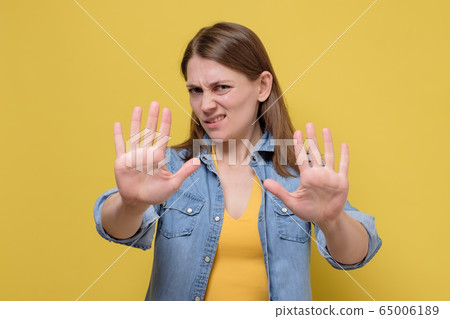 Young woman wearing casual clothes standing over Young woman wearing casual clothes standing over 65006189