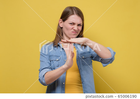 Young caucasian woman making time out gesture over 65006190