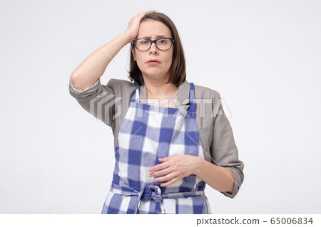 Sad upset tired businees woman in apron touch her Sad upset tired businees woman in apron touch her 65006834