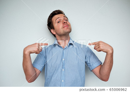 Self-satisfied and proud caucasian young man looks Self-satisfied and proud caucasian young man looks 65006962