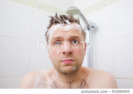Worried caucasian foamed young man after the water Worried caucasian foamed young man after the water 65006995